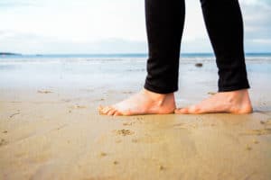 Vertigo Exercises Video, woman standing on beach barefoot